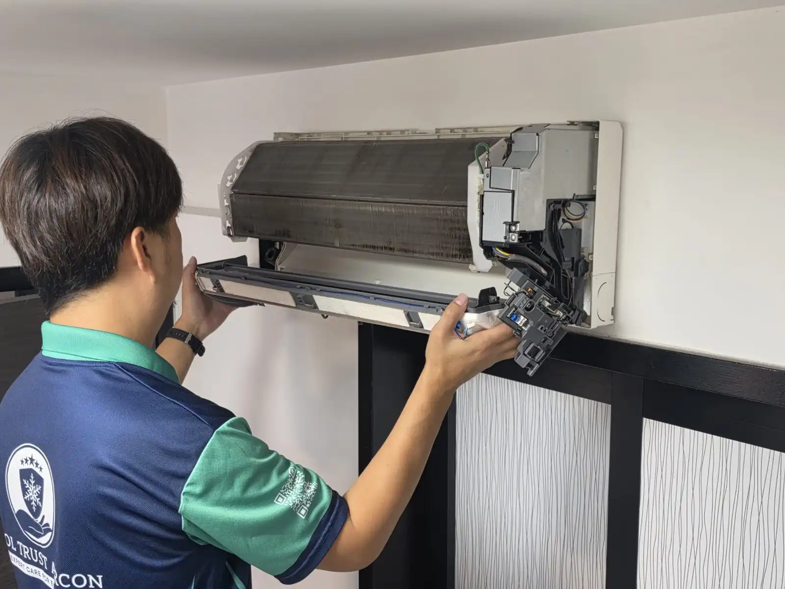 CoolTrust technician removing aircon drain pan